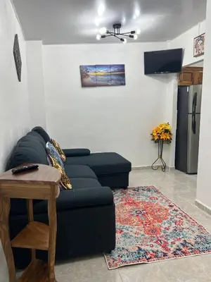 a living room with a couch and a table at Casa de Descanso en la Villa Panamericana in San Miguel