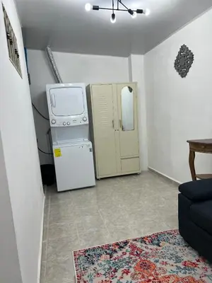 a small kitchen with a stove and a refrigerator at Casa de Descanso en la Villa Panamericana in San Miguel