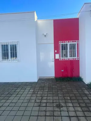 a red and white building with a red door at Lovely 2BDR home in EcoTerra, Santa Ana in Santa Ana