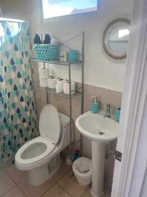 a bathroom with a toilet and a sink at Lovely 2BDR home in EcoTerra, Santa Ana in Santa Ana