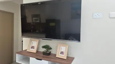 a shelf with two pictures and a potted plant on it at Stay with us just 5 minutes from the international airport of El Salvador in Las Flores