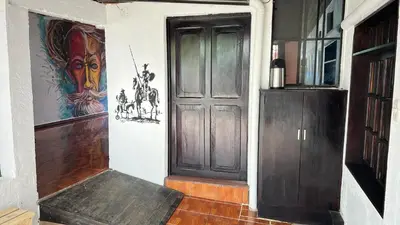 a room with a door and paintings on the wall at Casa Don Quijote in Concepción de Ataco