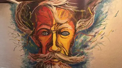 a painting of a mans face on a wall at Casa Don Quijote in Concepción de Ataco