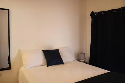 a bedroom with a bed with a black curtain at Casa Don Quijote in Concepción de Ataco