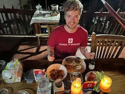 a man sitting at a table with food at Casa lichis habitación basica in Suchitoto