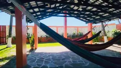 a couple of hammocks in a porch at Beachfront- El Torogoz del Pimental in La Esmeralda
