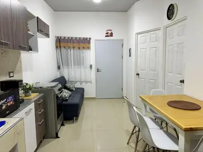 a kitchen and a living room with a table and chairs at Estancia El Torogoz - by Duran in Ahuachapán
