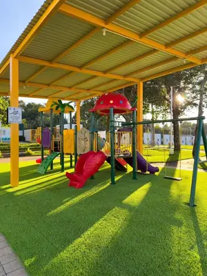 a playground with slides and play equipment in a park at Estancia El Torogoz - by Duran in Ahuachapán