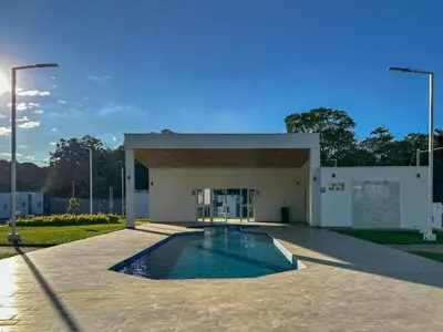 a building with a swimming pool in front of it at Estancia El Torogoz - by Duran in Ahuachapán