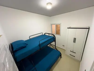 a small room with a bunk bed and a cabinet at Estancia El Torogoz - by Duran in Ahuachapán