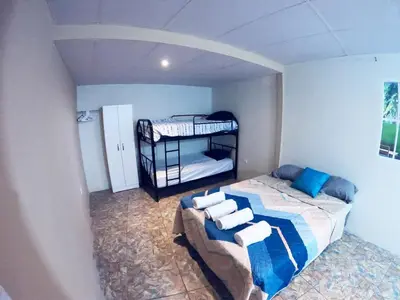 a bedroom with a bed with two bunk beds at Apartamento económico familiar in San Salvador