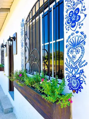 a window box with flowers on a building at Tres Cielos Cabañas in San Pedro Masahuat
