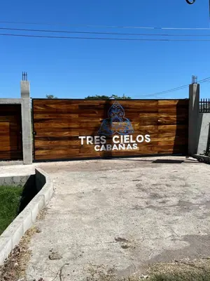 a wooden fence with a tree cities gardens sign on it at Tres Cielos Cabañas in San Pedro Masahuat