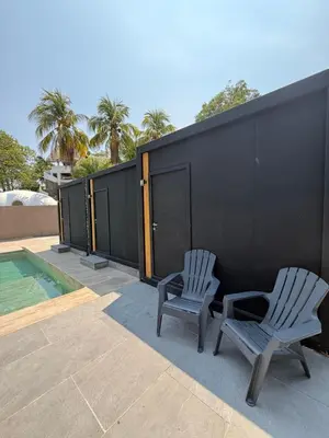 two chairs sitting on a patio next to a swimming pool at VUE by The Cabins in La Libertad