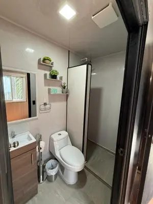 a small bathroom with a toilet and a shower at VUE by The Cabins in La Libertad