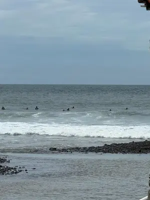 a group of people surfing in the ocean at VUE by The Cabins in La Libertad