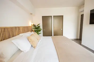a bedroom with a large white bed with white pillows at Modern Apartment 2 Bedrooms 2 Bathrooms WIFI in Las Delicias