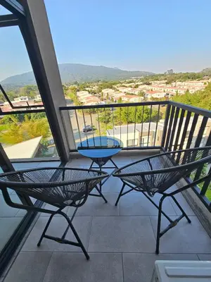 a patio with two chairs and a table on a balcony at Modern Apartment 2 Bedrooms 2 Bathrooms WIFI in Las Delicias
