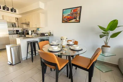 a kitchen and dining room with a table and chairs at Modern Apartment 2 Bedrooms 2 Bathrooms WIFI in Las Delicias