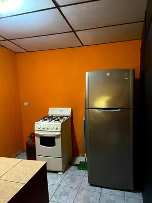 a kitchen with a stove and a refrigerator at Casa de Montaña en Los Naranjos in Los Naranjos