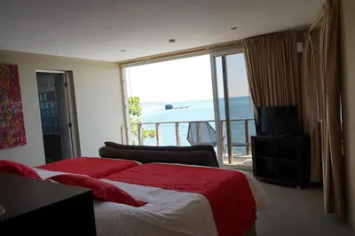 a hotel room with two beds and a view of the ocean at Casa de Mar Hotel And Villas in La Libertad
