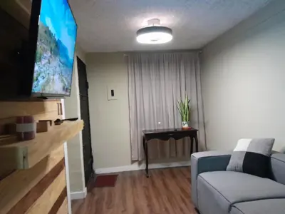 a living room with a couch and a flat screen tv at Casa en zona privada in San Salvador