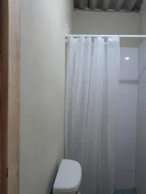 a bathroom with a toilet and a shower curtain at Casa en zona privada in San Salvador