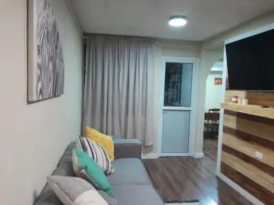 a living room with a couch and a flat screen tv at Casa en zona privada in San Salvador