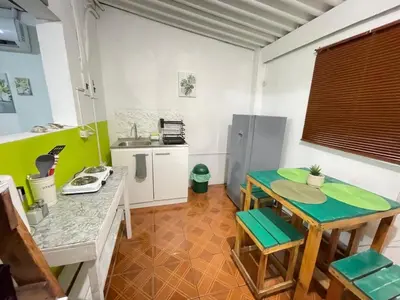 a kitchen with a small table and a kitchen with a refrigerator at Tunco Bambú Room 1 in Tamanique