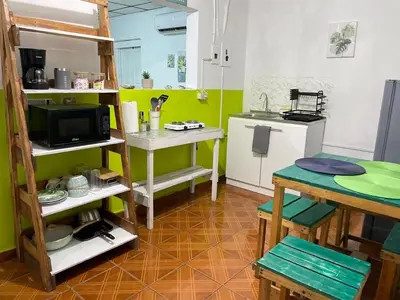 a small kitchen with a table and a microwave at Tunco Bambú Room 1 in Tamanique