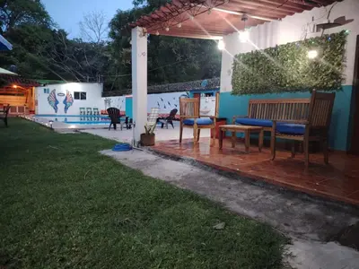 a patio with benches and a wall with graffiti at Tunco Bambú Room 1 in Tamanique