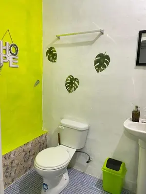 a bathroom with a toilet and a sink at Tunco Bambú Room 1 in Tamanique