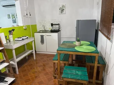 a small kitchen with a table and a counter at Tunco Bambú Room 1 in Tamanique