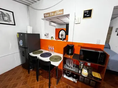 a small kitchen with a table and a microwave at Tunco Sun Room 2 in Tamanique