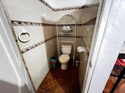 a small bathroom with a toilet in a room at Tunco Sun Room 2 in Tamanique