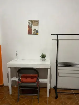 a white desk with a red pillow on a chair at Tunco Sun Room 2 in Tamanique
