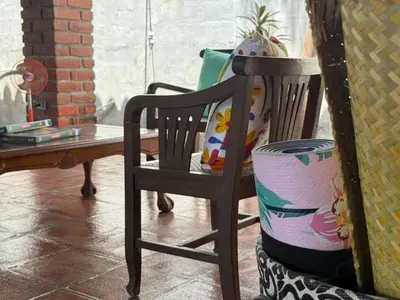 a wooden chair sitting next to a table with a plant at Casa DUNA 3 in Playa San Blas