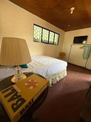 a bedroom with a bed and a table with a lamp at Casa DUNA 3 in Playa San Blas