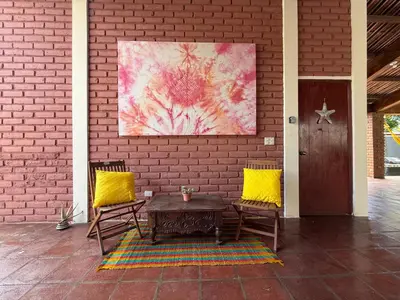 a patio with a table and two chairs and a painting at Casa DUNA 2 in La Libertad