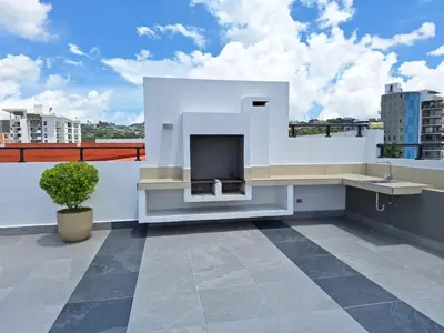 a white house with a fireplace on a roof at Acogedor y Centrico Apartamento in San Salvador