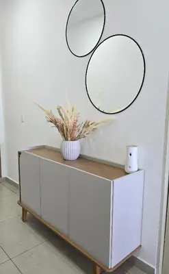 a white dresser with two mirrors on the wall at Acogedor y Centrico Apartamento in San Salvador