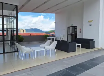 a living room with a couch and chairs on a balcony at Acogedor y Centrico Apartamento in San Salvador