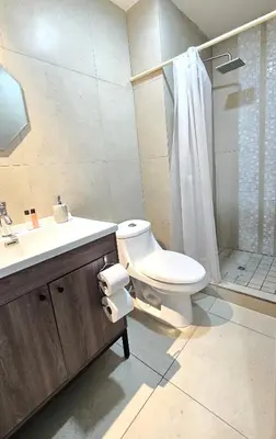 a bathroom with a toilet and a sink and a shower at Acogedor y Centrico Apartamento in San Salvador