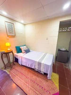 a small room with a bed with a rug at Casa DUNA 4 in La Libertad