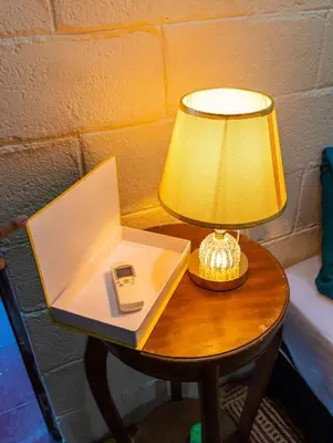 a table with a lamp and a phone on it at Casa DUNA 4 in La Libertad