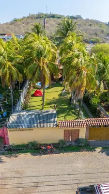 a view of a park with palm trees and a building at Casa DUNA 4 in La Libertad