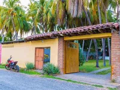 a small house with a motorcycle parked in front of it at Casa DUNA 4 in La Libertad