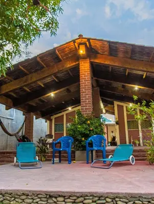 two blue chairs sitting under awning on a patio at Casa DUNA 4 in La Libertad