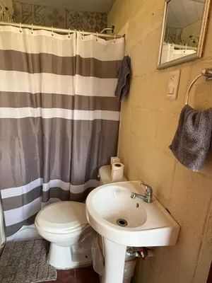 a bathroom with a toilet and a sink at Casa DUNA 4 in La Libertad