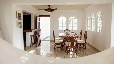 a dining room with a table and chairs at Casa Tropical Kaylani in Tamanique